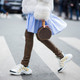 PARIS, FRANCE - MARCH 06: Lisa Hahnbueck wearing white fur jacket Dorothee Schumacher, blue dress Baum und Pferdgarten, leather pants Hironae Paris, Archlight Louis Vuitton sneakers, round Louis Vuitton bag is seen during Paris Fashion Week Womenswear Fall/Winter 2018/2019 on March 6, 2018 in Paris, France. (Photo by Christian Vierig/Getty Images)